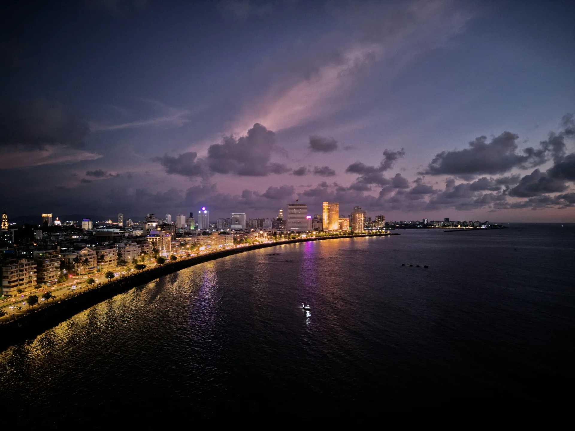 Aerial night view of Marine Drive and the illuminated south Mumbai skyline across the bay